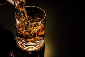 Whiskey being poured into a glass